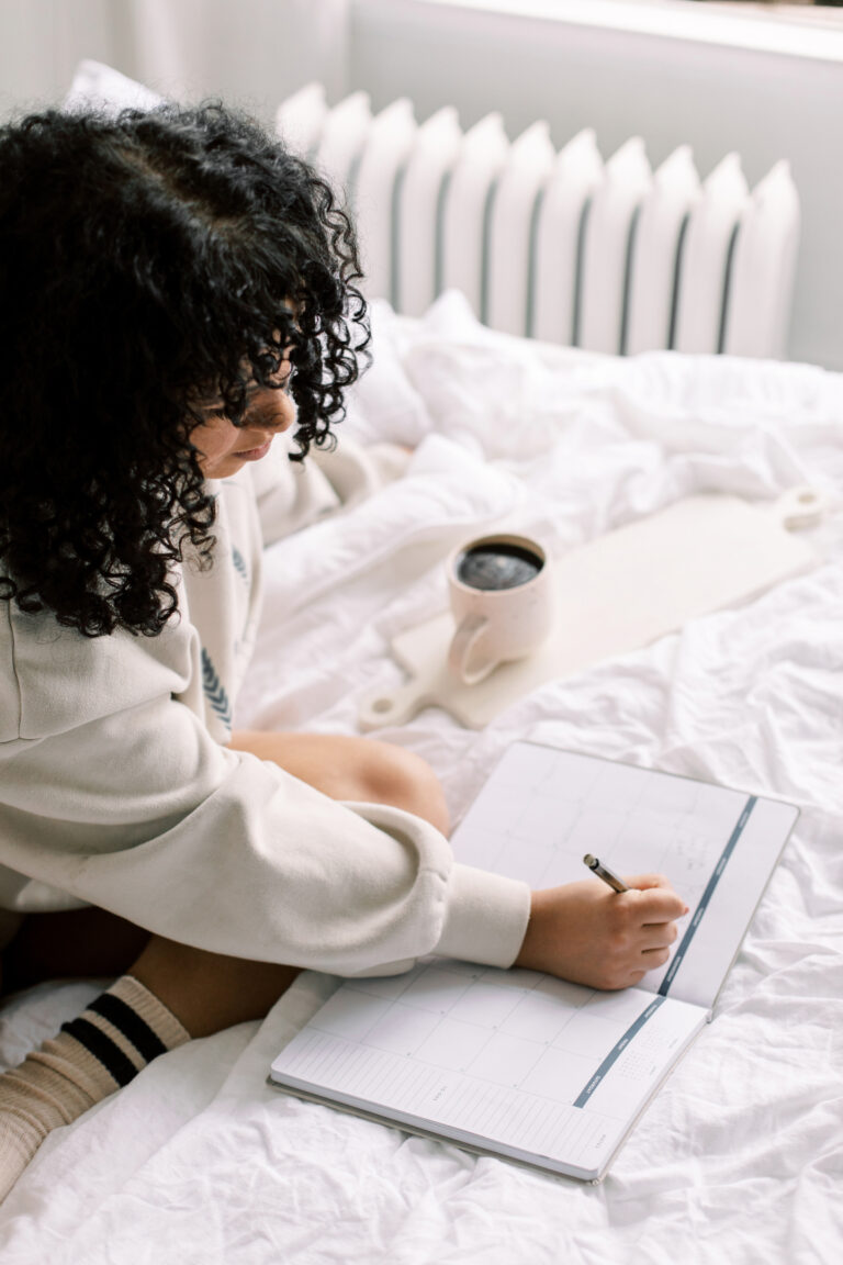 women writing negative feelings in journal
