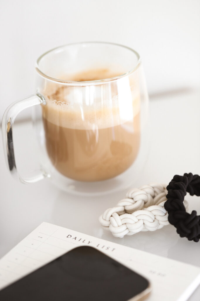 coffee cup, hair ties, phone and daily list