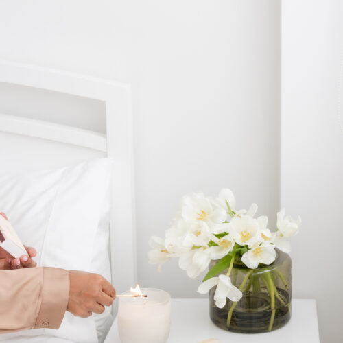 woman lighting a candle
