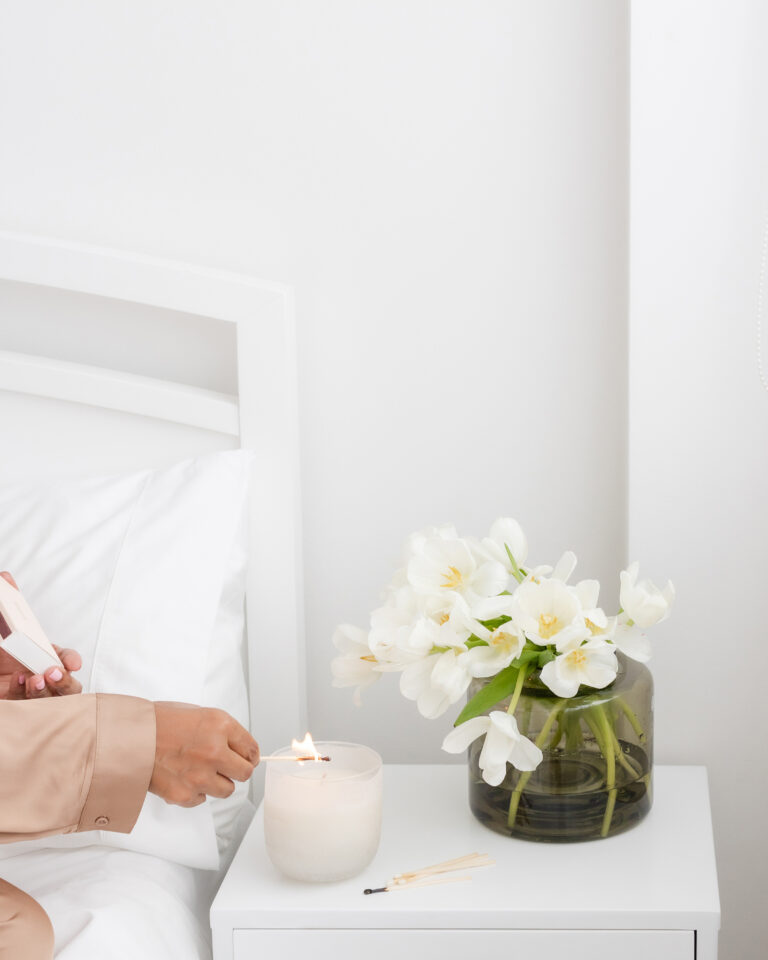 woman lighting a candle
