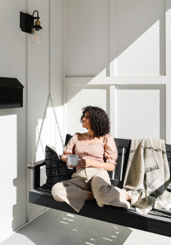 woman sitting in swing practicing self-care