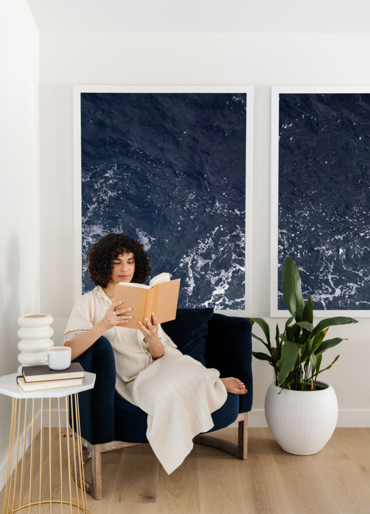 woman reading in chair practicing self-care