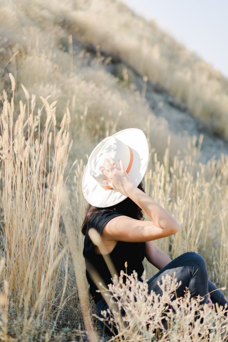 woman sitting in a field practicing mindfulness