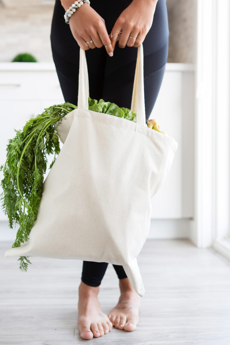 woman holding bag with healthy groceries