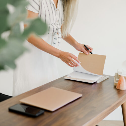 woman setting small goals in a notebook
