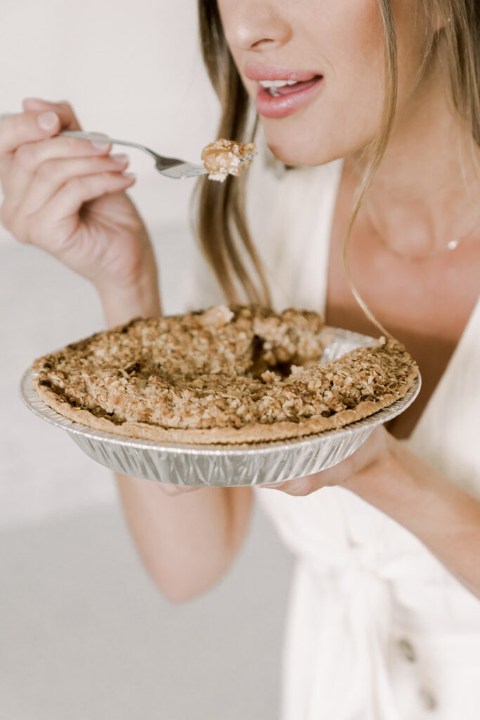 woman eating pie directly from the pie plate