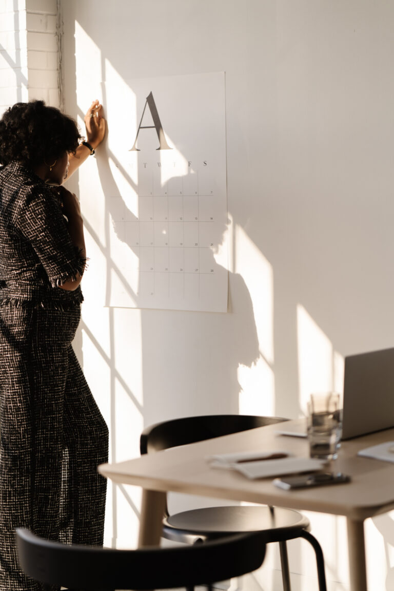 woman looking at a calendar to overcome barriers to success