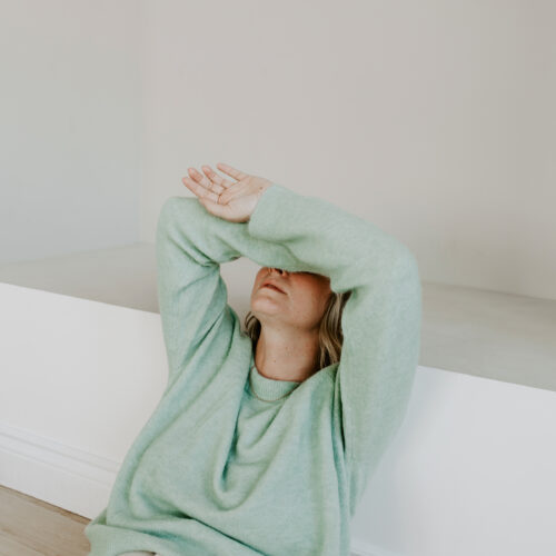 woman with hands over hear head
