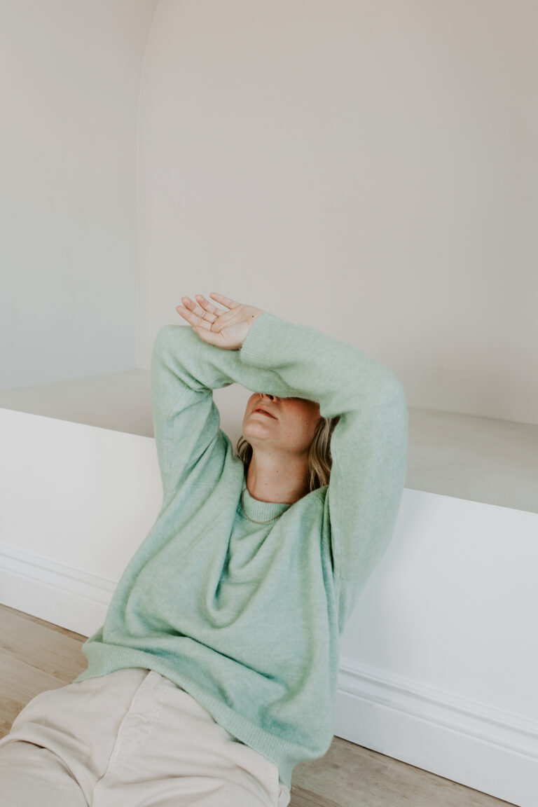 woman with hands over hear head