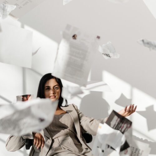 women throwing papers in the air