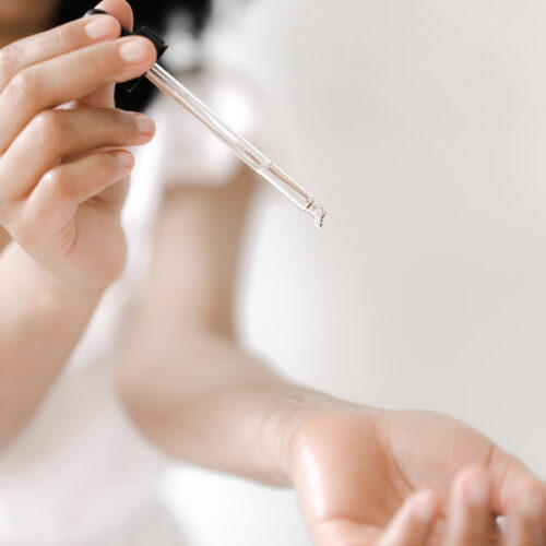 woman putting essential oils on her wrist for mindfulness