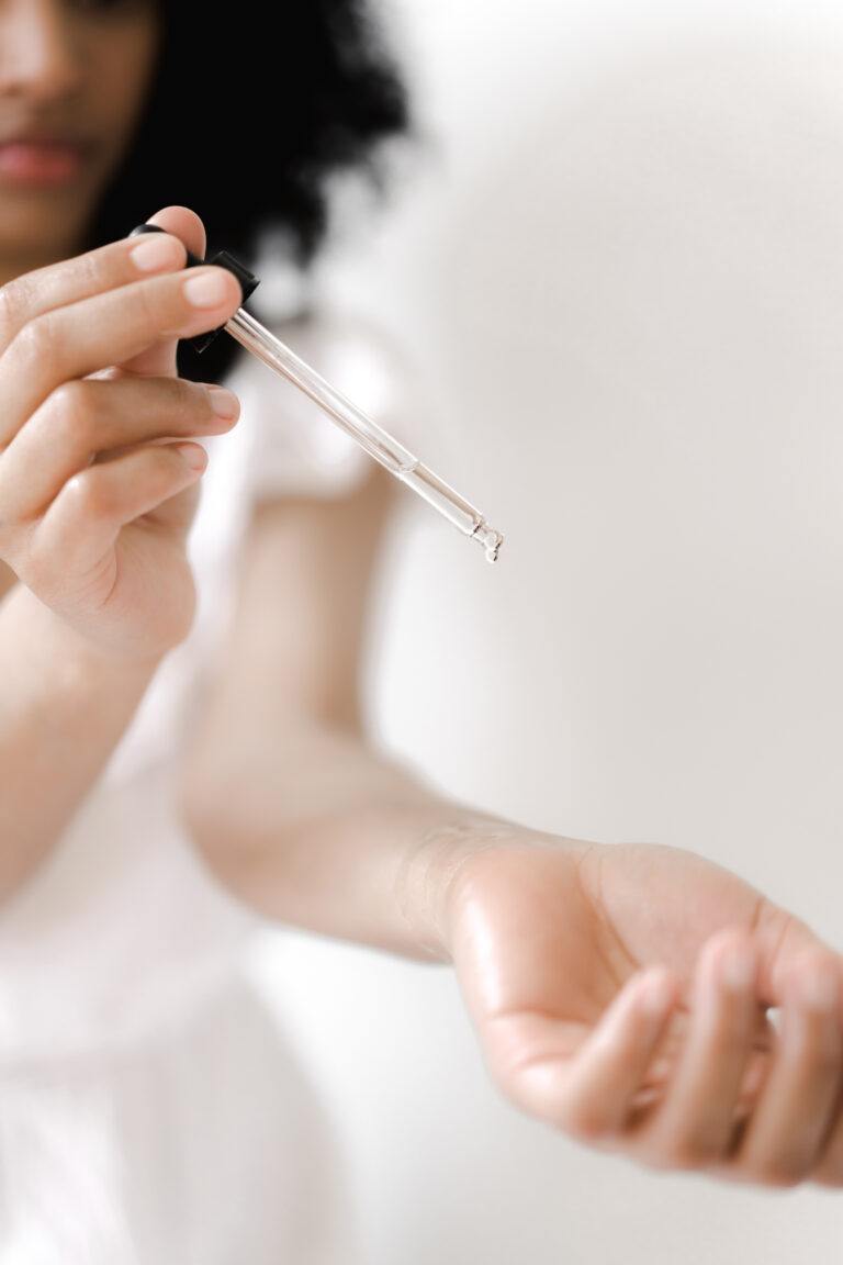 woman putting essential oils on her wrist for mindfulness