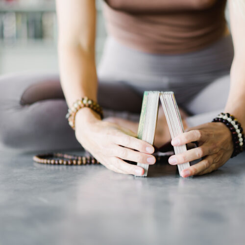 woman holding mindful cards for adults