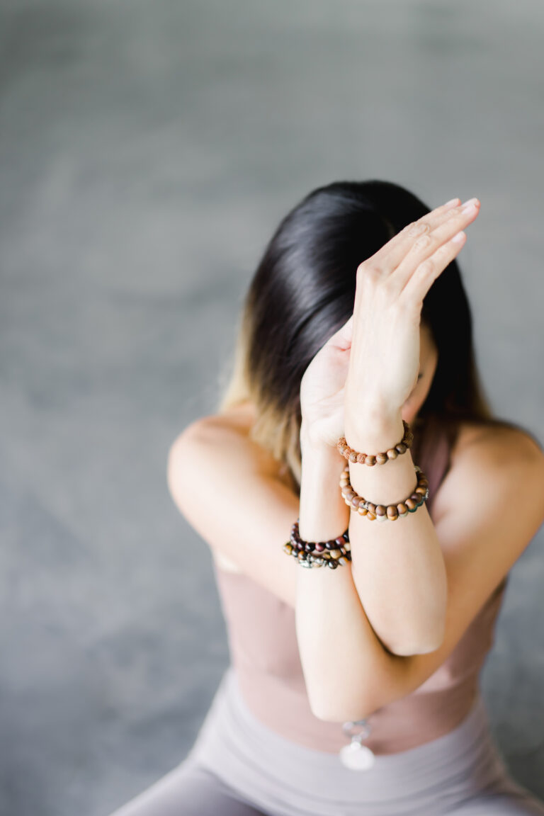 woman doing eagle yoga pose
