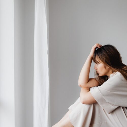 woman sitting on a table thinking