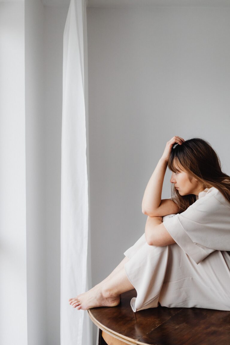 woman sitting on a table thinking