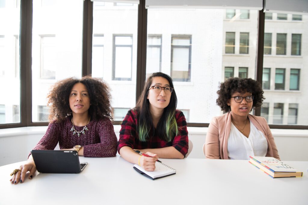three women listening to someone talking