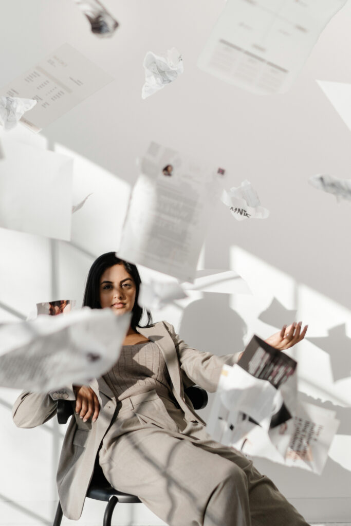 woman at work throwing papers in the air