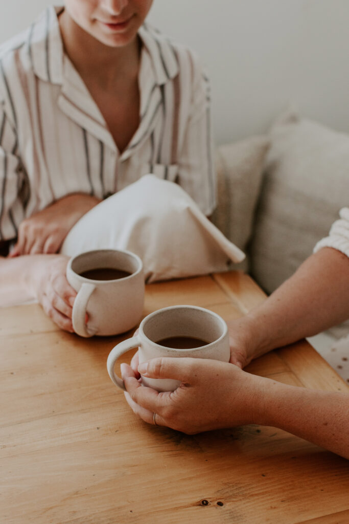 two women talking at table with coffee